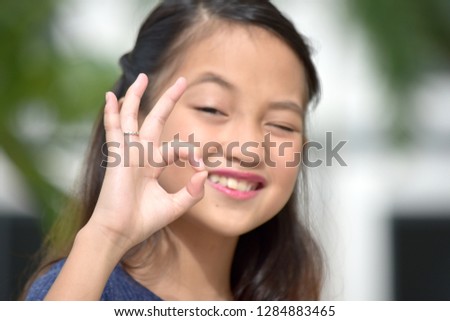 Youthful Minority Girl And Okay Sign
