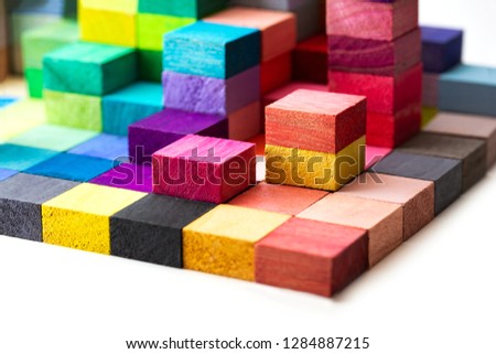 Spectrum of stacked multi-colored wooden blocks. Background or cover for something creative, diverse, expanding,  rising or growing.