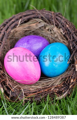 Easter eggs in a nest on a background of green grass