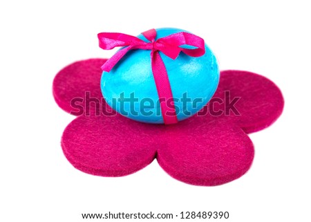 Easter egg on the red flower, on a white background