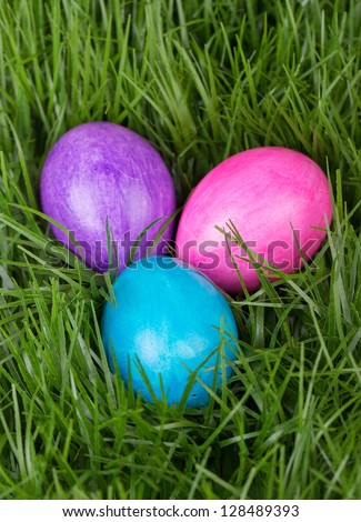 Colored Easter eggs in the green grass