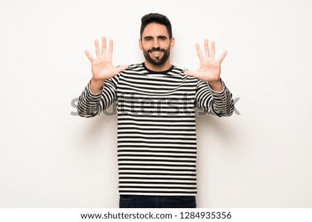 handsome man with striped shirt counting ten with fingers