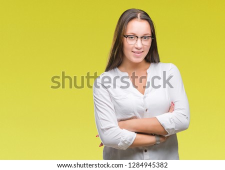 Young caucasian beautiful business woman wearing glasses over isolated background happy face smiling with crossed arms looking at the camera. Positive person.