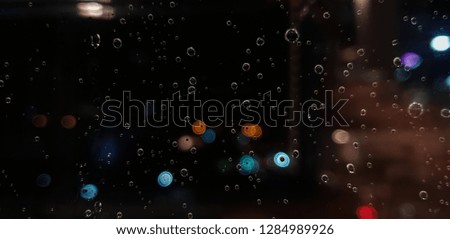Drop of water rain on window glasses surface with City light blur background. Photos from mobile