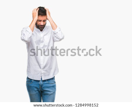 Adult hispanic man over isolated background suffering from headache desperate and stressed because pain and migraine. Hands on head. Royalty-Free Stock Photo #1284998152
