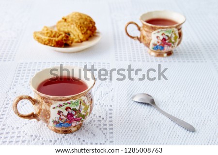 two mug with tea, on a white tablecloth. sweet roll on the plate