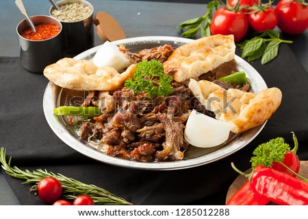 tandir kebab traditional turkish cuisine on black background lamb meat kuzu Royalty-Free Stock Photo #1285012288