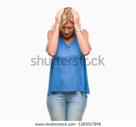 Middle age blonde woman over isolated background suffering from headache desperate and stressed because pain and migraine. Hands on head.