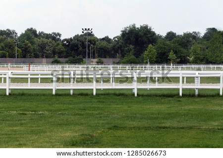 Empty racing track racecourse without horses and riders 