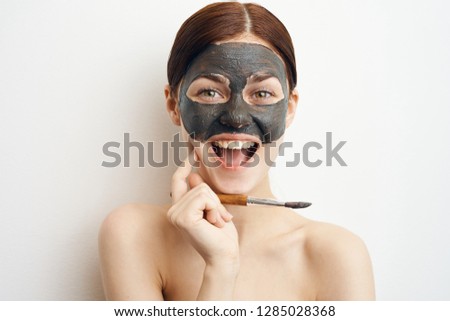 joyful woman in a cosmetic mask