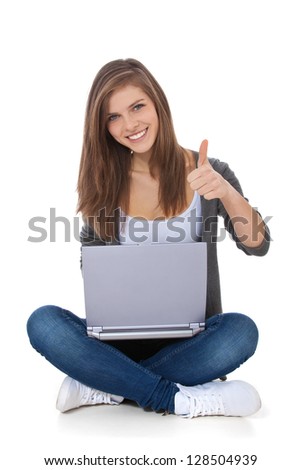 Attractive teenage girl using laptop. All on white background.