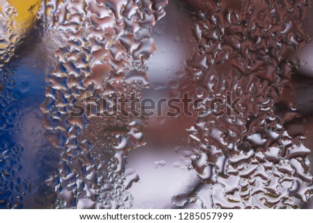 Water drops on glass window close up with blurred background. Drops in macro. Condensate on window closeup. Wet air.
