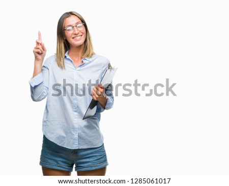 Young beautiful inspector business woman over isolated background surprised with an idea or question pointing finger with happy face, number one