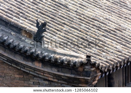 Typical decorated roofs of the houses of Pingyao Ancient city, Shanxi province, China. Known as one of the best preserved villages of China, Pingyao is a UNESCO World Heritage Site