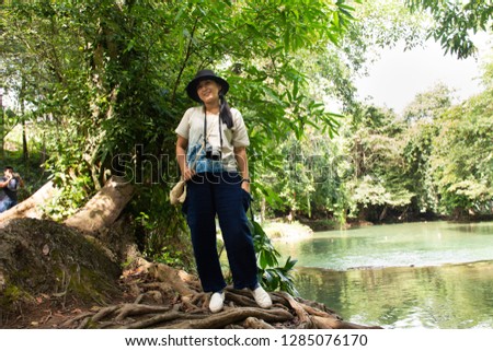 Traveler thai woman travel and posing for take photo at Chet Sao Noi small waterfalls or Namtok Chet Sao Noi National Park at Muak Lek District in the Saraburi Province of Thailand.