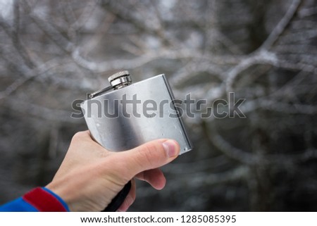 Drinking alcohol in the mountains in the mountains from hipflask