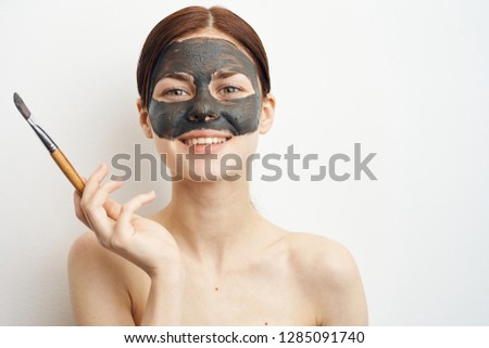 woman smiling in a clean fresh skin cosmetic mask