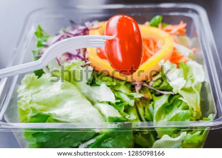 Man is eating of fresh vegetable salad is healthy lunch on table, Clean and balanced healthy food concept.