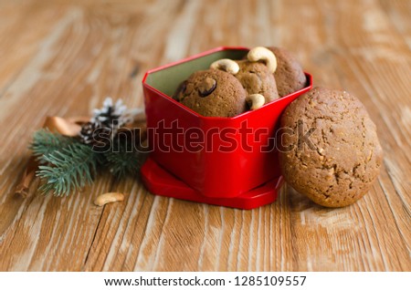 Set of homemade coffee cookies with chocolate in red box on wooden background