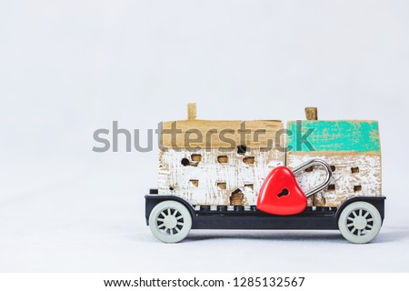 wood model with red heart pad lock on old car toy on white background with copy space. Conceptual image that show love protect and inspire people or center of happy home