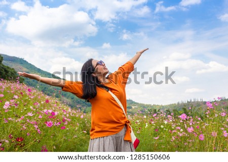 Asian lady feeling happy in flower garden