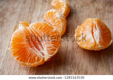 Orange slices of tangerines on a wooden board. Macro picture.