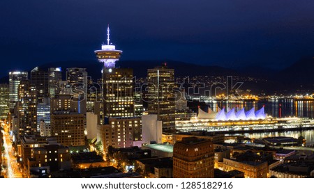 Beautiful view of the modern cityscape from an aerial perspective at night. Taken in Downtown Vancouver, BC, Canada.