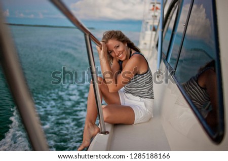 Portrait of a smiling mid adult woman relaxing on a boat.