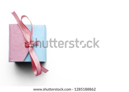 Pink and blue jewelry box with a pink ribbon on a white background.Copy space.