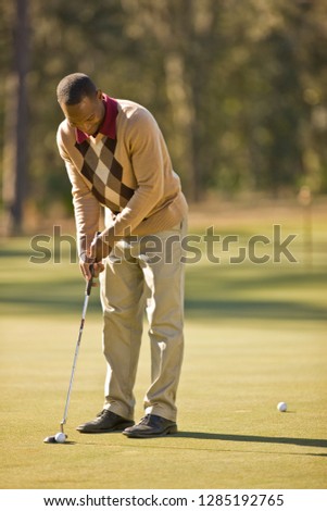 Man putting golf ball