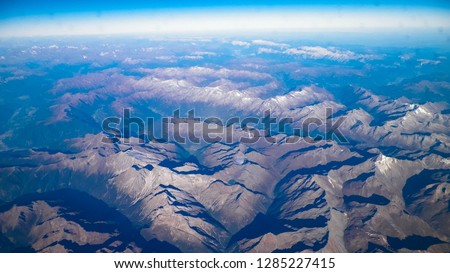 Horizon of the planet earth and Alps mountain tops. View from spaceship or plane.