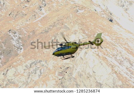 Helicopter rescue - Helicopter flying over the mountain.