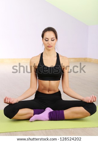 Young women in yoga style, at gym