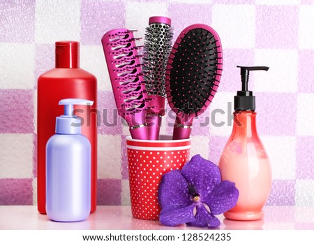 Hair brushes and cosmetic bottles in bathroom