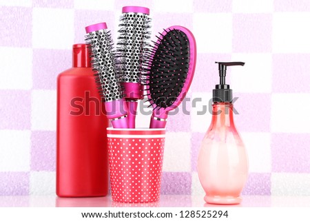 Hair brushes and cosmetic bottles in bathroom