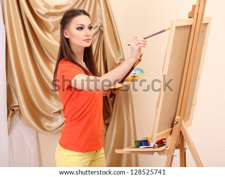beautiful young woman painter at work, isolated on white