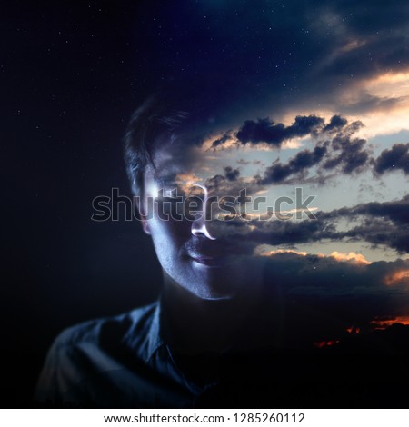 Intelligence and psychology, the concept of the inner world of man. Meditation, silhouette of a man and the sky with clouds, double exposure