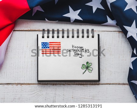 St.Patrick's Day. Beautiful card. Notepad with congratulatory inscription. Isolated background, close-up, top view, wooden surface. Congratulations for loved ones, relatives, friends and colleagues 