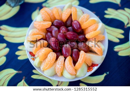 White plate, with grapes and orange Healthy and beauty fruits concept. art food decoration. 