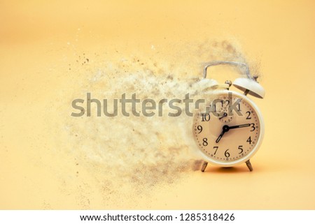 White clock that represents the end of time or that time is destroyed with golden background.