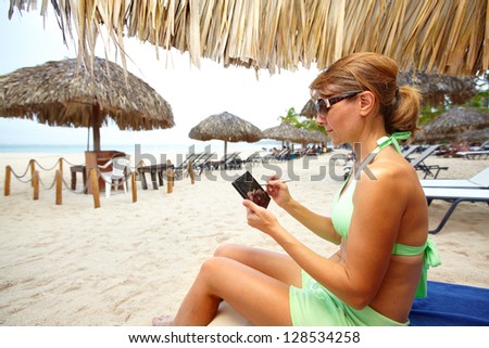 Woman with a smartphone on the beach. Vacation.