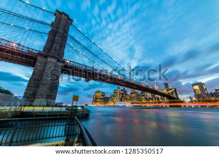 Brooklyn Bridge with Manhattan skyscrapers background. New York City, USA. Brooklyn Bridge is linking Lower Manhattan to Brooklyn.
