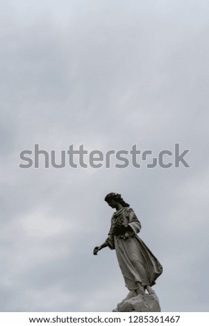 A statue of a woman atop a mortuary