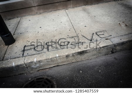 Forgive written on the sidewalk