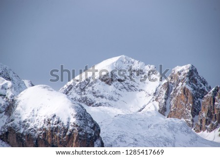 Catinaccio Mountains after snowfall, and lowest mountain at first view. Winter into dolomite range, mountains of alps. Val di Fassa Landscape in winter