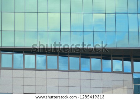 Modern building with reflected sky and cloud in glass window