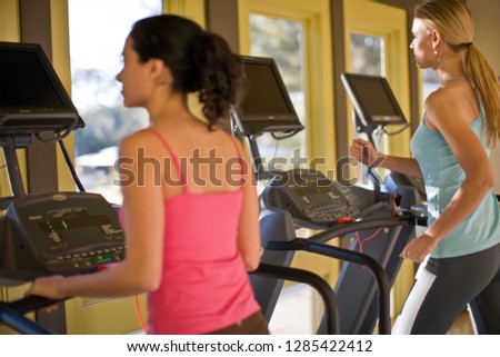 Young women working out on treadmills
