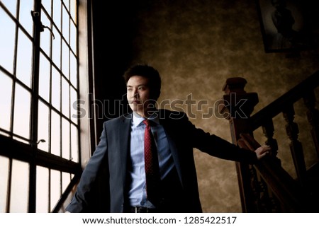 Businessman standing on a staircase.
