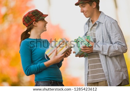 Teenage couple exchanging gifts