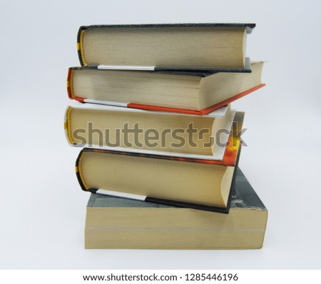 Pile of books on a table in white background